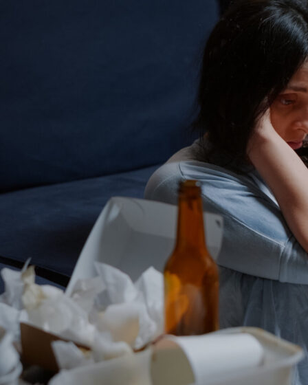 sad woman sitting alone on floor.