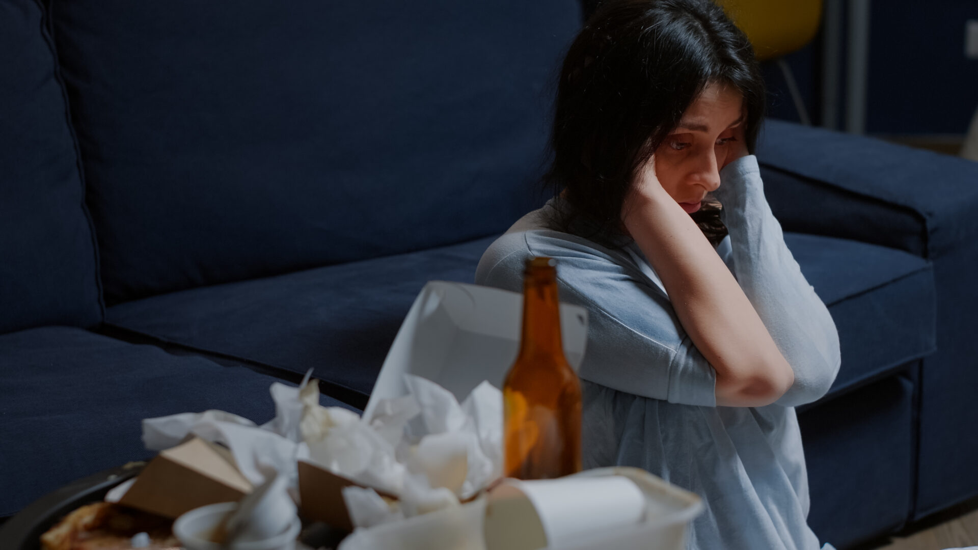 sad woman sitting alone on floor.